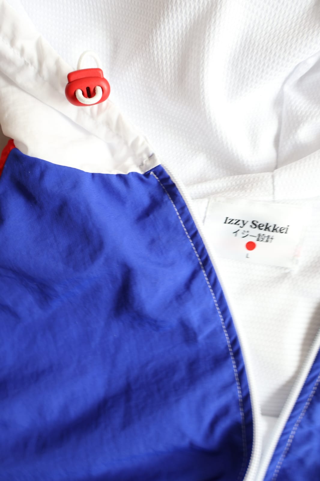 IZZY SEKKEI ZIP UP WINDBREAKER